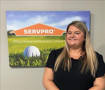 A female SERVPRO employee is shown in a black shirt