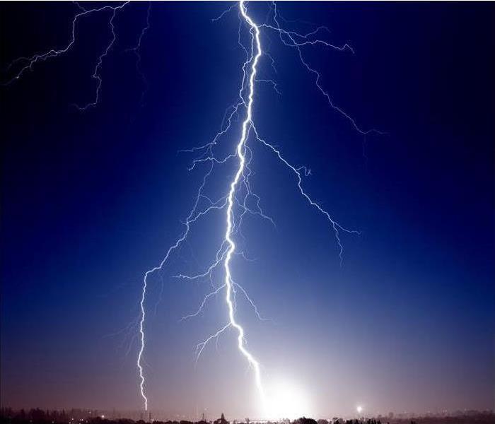 Lightning is shown in a dark sky