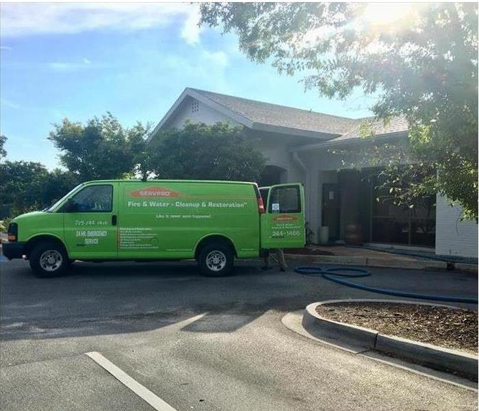 A green SERVPRO van is shown at a work site 