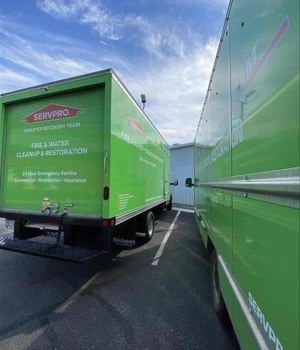 2 green SERVPRO box trucks