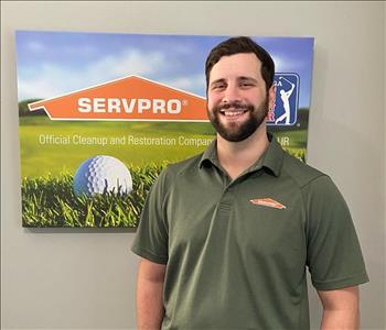 A male SERVPRO employee is shown in a green shirt with SERVPRO logo